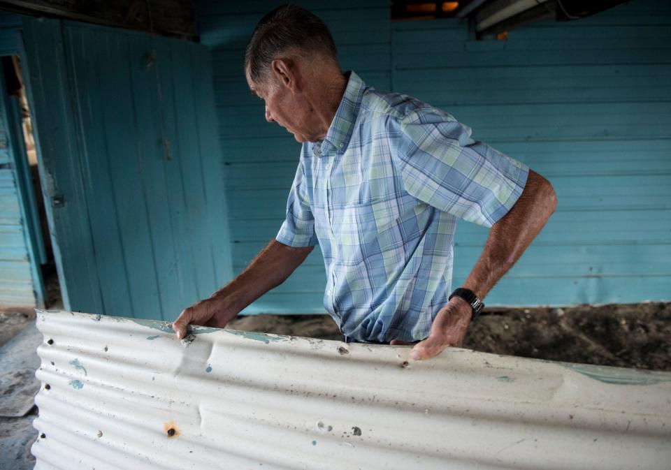 Lee Morvant clears the area underneath his fish camp in Isle de Jean Charles, La., on Friday, July 12, 2019. Isle de Jean Charles is slowly shrinking due to rising sea levels. 