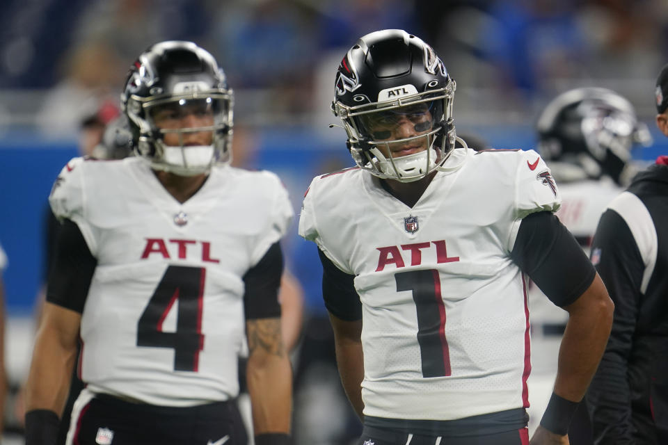 FILE - Atlanta Falcons quarterbacks Marcus Mariota (1) and Desmond Ridder (4) prepare before a preseason NFL football game against the Detroit Lions in Detroit, Friday, Aug. 12, 2022. The Atlanta Falcons released quarterback Marcus Mariota on Tuesday, Feb. 28, 2023, in a move that was expected after the veteran was benched late in the 2022 season.The Falcons were 5-8 with Mariota as the starter before rookie Desmond Ridder started the final four games, winning two. (AP Photo/Paul Sancya, FILE)