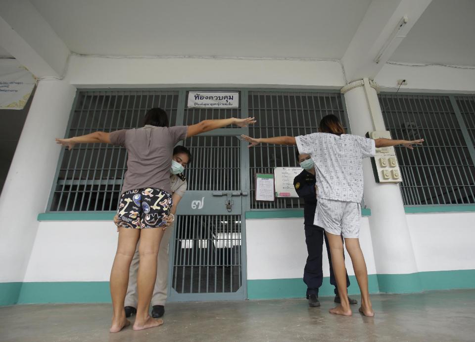 In this Jan. 6, 2017 photo, transgender inmates get a security check from female officers before entering their cell at Pattaya Remand Prison in Pattaya, Chonburi province, Thailand. The prison separates lesbian, gay, bisexual and transgender prisoners from other inmates, a little-known policy despite being in place nationwide since 1993, according to the Department of Corrections. (AP Photo/Sakchai Lalit)