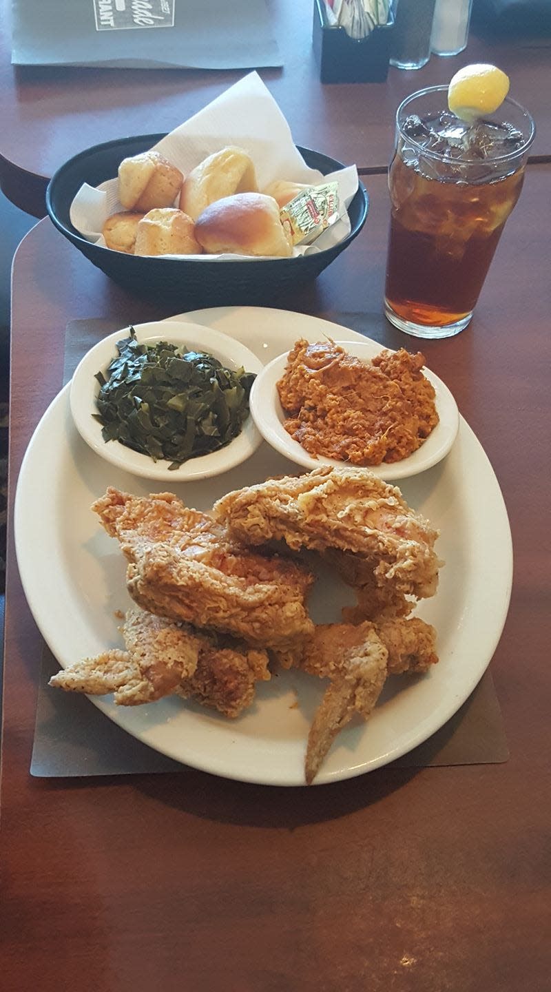 FILE - The Colonnade's fried chicken, greens and rolls. The Atlanta restaurant is one of many in Georgia featured on Food Network's "Diners, Drive-Ins and Dives" with Guy Fieri.