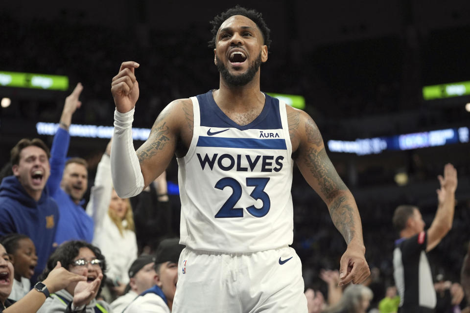 Minnesota Timberwolves guard Monte Morris (23) celebrates after making a 3-point shot at the buzzer to end the third quarter of an NBA basketball game against the Toronto Raptors, Wednesday, April 3, 2024, in Minneapolis. (AP Photo/Abbie Parr)