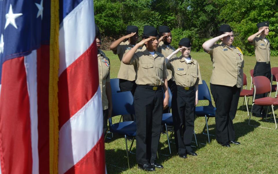 Cadets salute during the opening steps of the flag retirement ceremony.