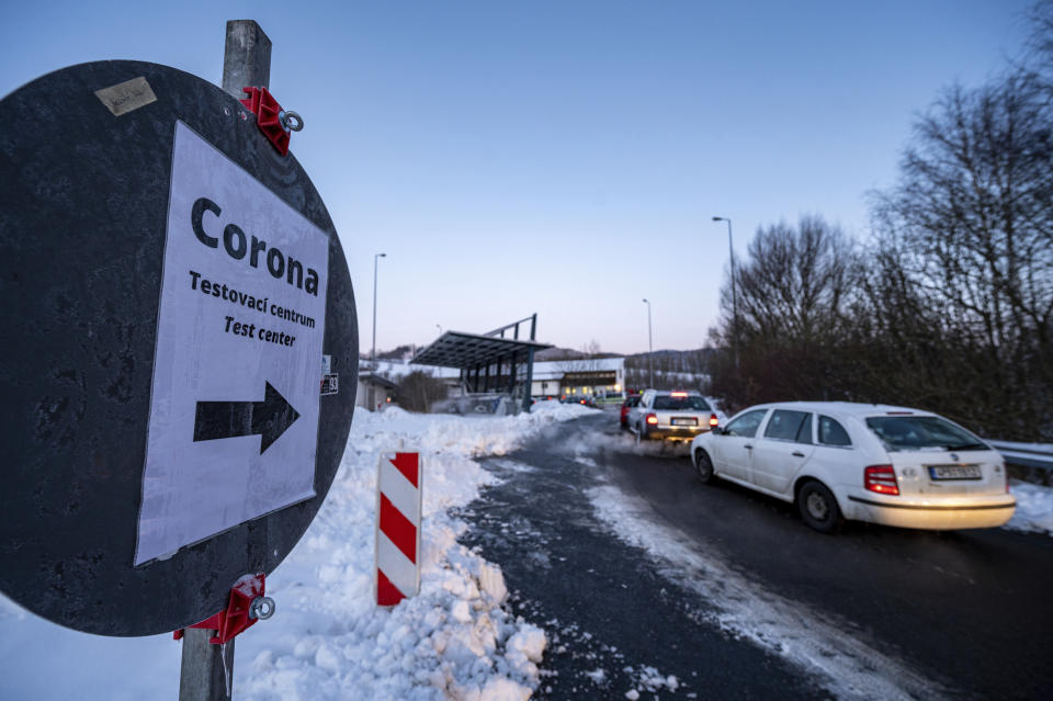 Cars queue in front of a Corona test station at the German-Czech Republic border in Furth im Wald, Germany, Monday, Jan. 25, 2021. German police say hundreds of cars and pedestrians are lining up at border crossings along the Czech-German border after Germany declared the Czech Republic a high risk area in the pandemic meaning it requires proof a negative coronavirus test results before entry. (Armin Weigel/dpa via AP)