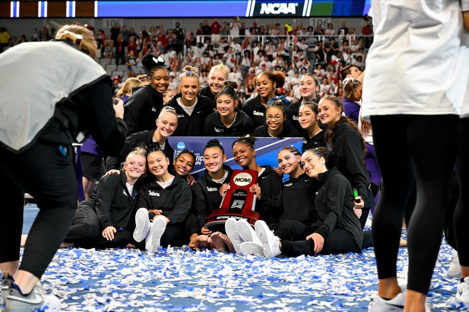 Apr 15, 2023; Fort Worth, TX, USA; The University of Florida Gators  celebrate with the second place trophy after the national championship at the NCAA Women's National Gymnastics Tournament Championship at Dickies Arena. Mandatory Credit: Jerome Miron-USA TODAY Sports