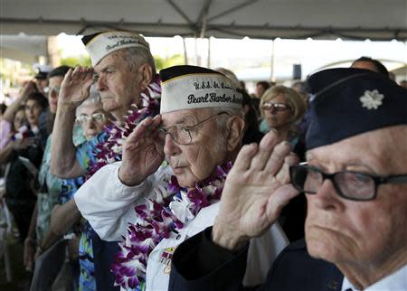 Pearl Harbor survivor Peyton Smith (C) salutes during the "Moment of Silence" while attending the 72nd anniversary of the attack on Pearl Harbor at the WW II Valor in the Pacific National Monument in Honolulu, Hawaii December 7, 2013. REUTERS/Hugh Gentry