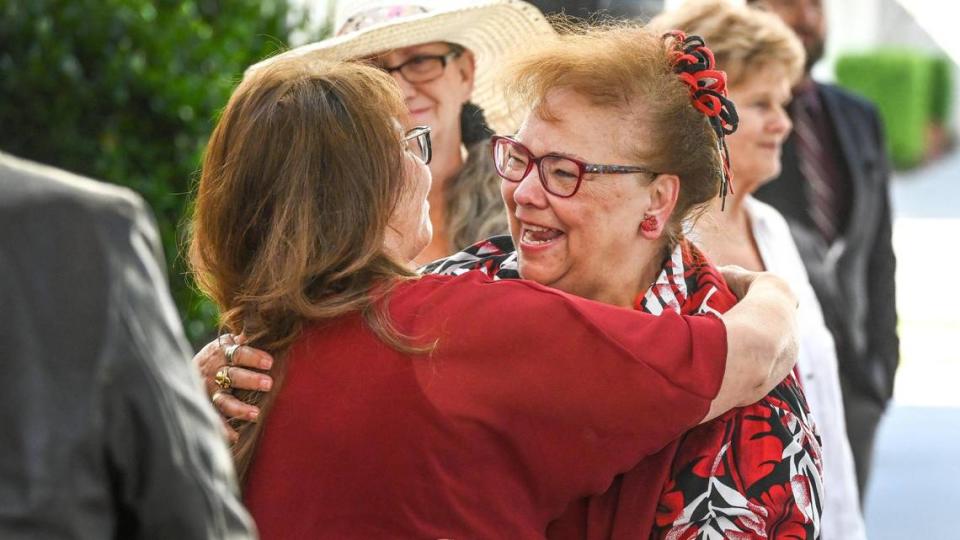 Sharon Lamb, a Clovis Unified teacher for 50 years and current kindergarten teacher at Red Bank Elementary, hugs family, friends and co-workers after being honored with a special dedication in the school’s yearbook during a surprise presentation on Friday, June 2, 2023.