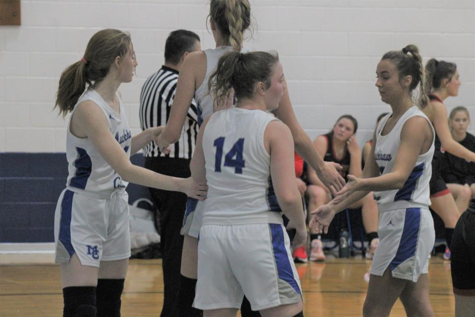Mackinaw City's Larissa Huffman, Madison Smith, Jersey Beauchamp and Marlie Postula congratulate each other after forcing a turnover during the second half against Onaway on Thursday.