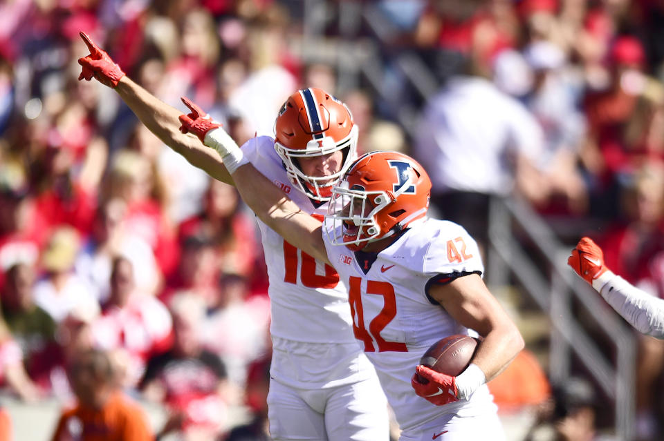 Illinois' Luke Zardzin (42) celebrates recovering a Wisconsin fumble with defensive back Peyton Vining (16) during the second half of an NCAA college football game Saturday, Oct. 1, 2022, in Madison, Wis. (AP Photo/Kayla Wolf)