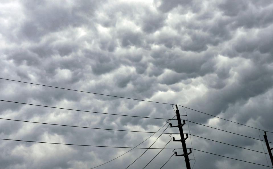 Clouds amass over power lines follow days of storms on Sunday, May 5, 2024, in Humble, Texas. (Elizabeth Conley/Houston Chronicle via AP)