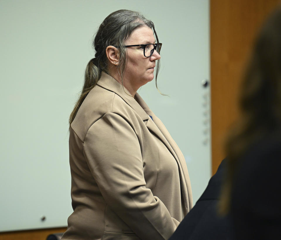 Defendant Jennifer Crumbley stands at the start of her trial at Oakland County Courthouse, Tuesday, Jan. 30, 2024, in Pontiac, Mich. Crumbley, 45, is charged with involuntary manslaughter. Prosecutors say she and her husband were grossly negligent and could have prevented the four deaths if they had tended to their son’s mental health. They’re also accused of making a gun accessible at home. (Clarence Tabb Jr./Detroit News via AP)