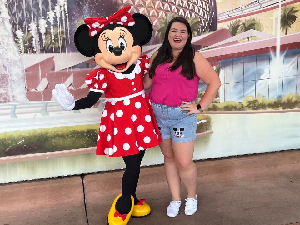 megan posing with minnie mouse at disney world as an adult