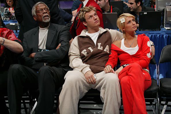 LOS ANGELES, CA - FEBRUARY 15: Bill Russell, Nick Carter and Paris Hilton seen court side during the All Star Game as part of 2004 NBA All Star Weekend on February 15, 2004 in Los Angeles, California at the Staples Center. NOTE TO USER: User expressly acknowledges and agrees that, by downloading and/or using this Photograph, User is consenting to the terms and conditions of the Getty Images License Agreement (Photo by Jesse D. Garrabrant/NBAE via Getty Images)