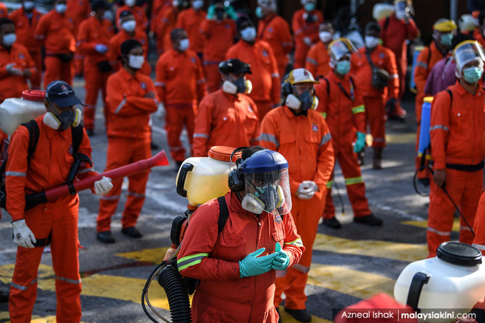 Firefighters wearing protective suits pray before a disinfection operation at Masjid Sri Petaling on Mar 28, 2020.<p><br></p>