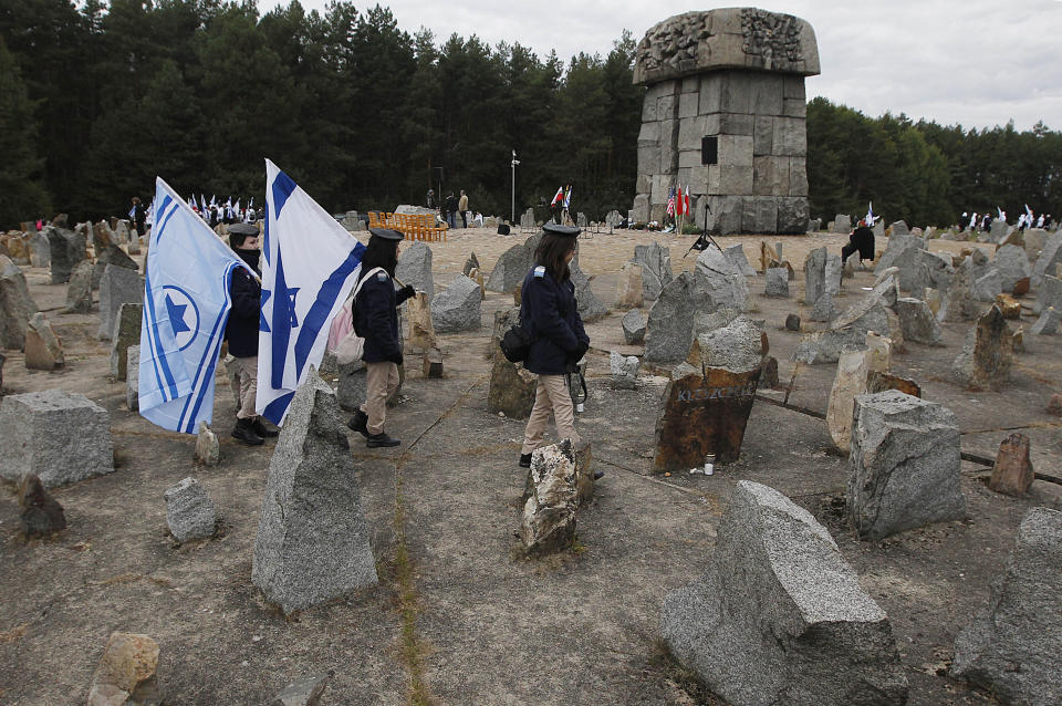 In this Wednesday, Oct. 2, 2013 Photo Israeli youths with their national flags march by the monument to some 900,000 European Jews killed by the Nazis between 1941 and 1944 at the Treblinka death and labor camp, at Treblinka memorial, Poland. Ada Krystyna Willenberg, the widow of one revolt fighter Samuel Willenberg, appealed Thursday for a proper museum to be built at the site of the former camp. The current memorial consists of boulders bearing the names of locations that the inmates came from. (AP Photo/Czarek Sokolowski, file)