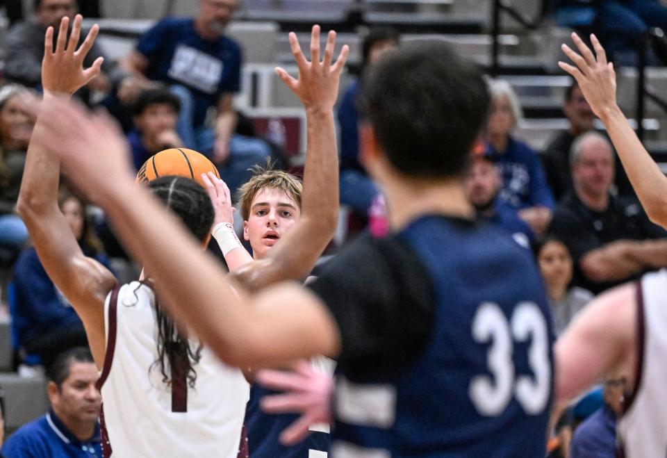 Redwood's Zander Jensen looks to pass against Mt. Whitney in an East Yosemite League high school boys basketball game Tuesday, January 23, 2024.