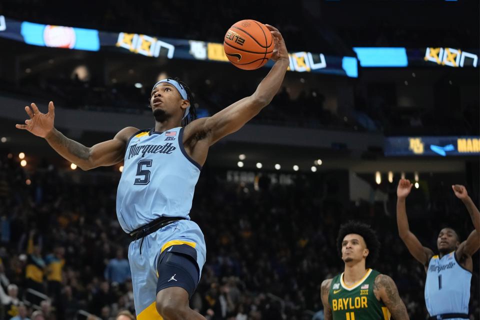 Marquette's Chase Ross dunks during the first half of an NCAA basketball game Tuesday, Nov. 29, 2022, in Milwaukee. (AP Photo/Morry Gash)