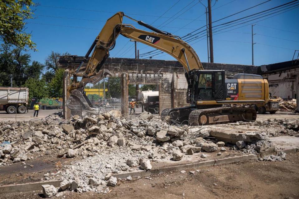 Crews work on demolition on the property at 19th Street and Broadway, south of X Street and west of the rail tracks, on Tuesday, July 18, 2023, in Sacramento. The long-vacant office building is being demolished to make way for a 140-unit affordable housing apartment building.