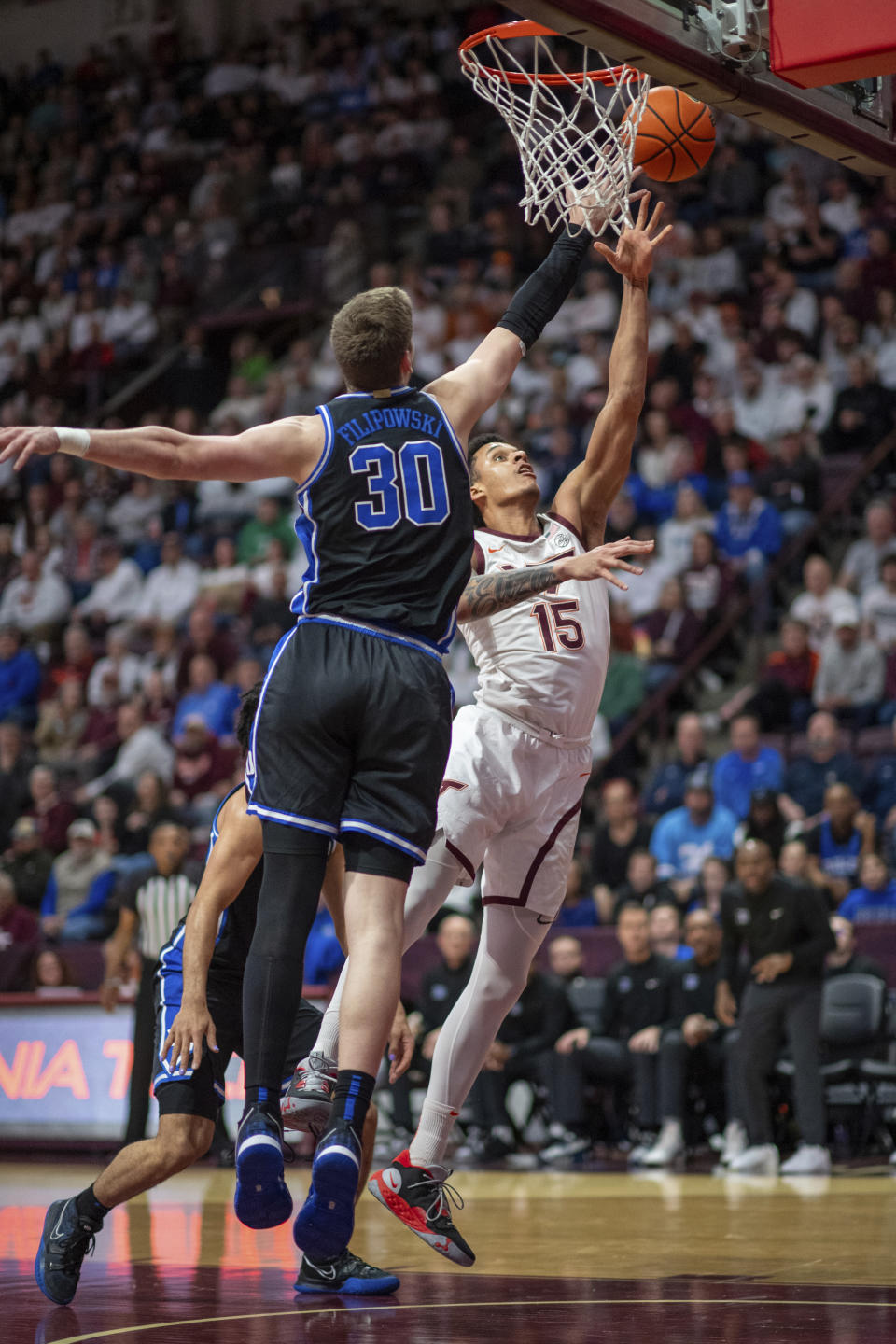 Virginia Tech's Lynn Kidd (15) shoots over Duke's Kyle Filipowski (30) during the first half of an NCAA college basketball game, Monday, Jan. 29, 2024, in Blacksburg, Va. (AP Photo/Robert Simmons)