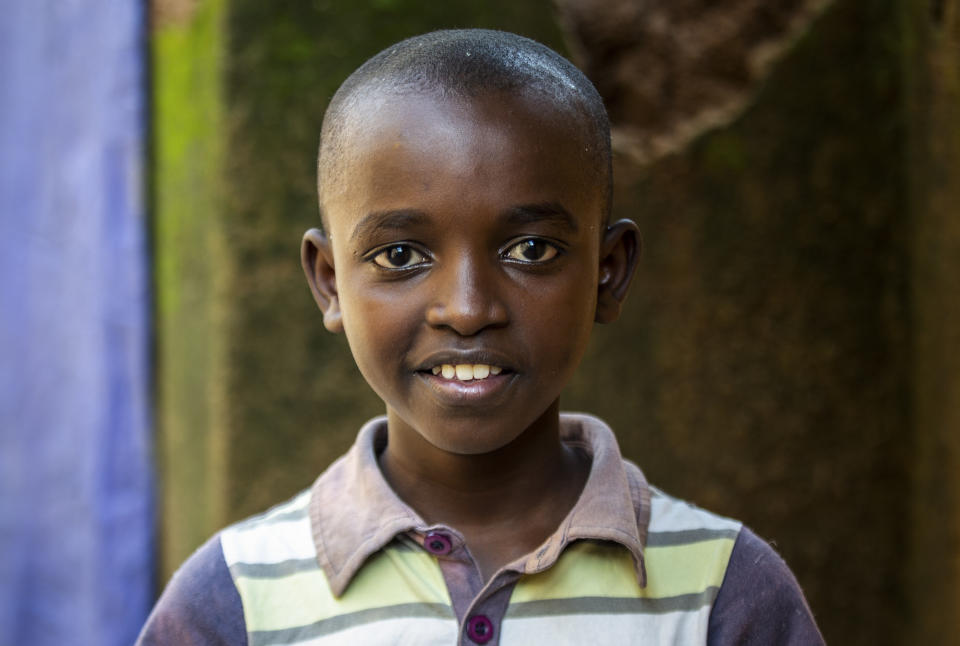 Tresor Ndizihiwe, 12, poses for a photo at his home in Kigali, Rwanda on Tuesday, April 21, 2020. No school. No playing with friends. Soldiers everywhere. That’s life during the coronavirus pandemic for Tresor Ndizihiwe, a 12-year-old boy who lives in Rwanda, one of seven brothers and sisters. (AP Photo)