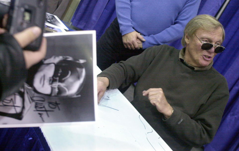 <p>A fan holds a Batman photograph signed by Adam West, right, at Cobo Hall during the 50th Autorama in Detroit, Saturday, Feb. 23, 2002. (Photo: Paul Warner/AP) </p>