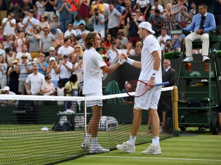 Tennis - Wimbledon - All England Lawn Tennis and Croquet Club, London, Britain - July 9, 2018 Greece's Stefanos Tsitsipas shakes hands with John Isner of the U.S. after losing their fourth round match REUTERS/Tony O'Brien