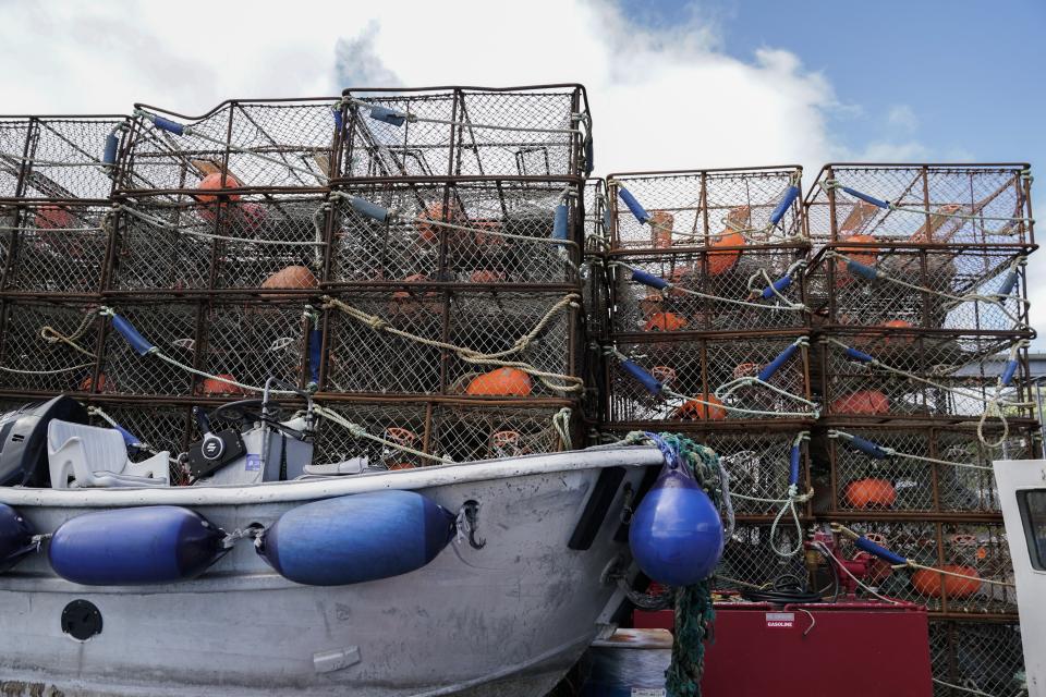 FILE - Crab pots sit on a dock, Sunday, June 25, 2023, in Kodiak, Alaska. Alaska fishermen will be able to harvest red king crab, the largest and most lucrative of all the Bering Sea crab species, for the first time in two years, offering a slight reprieve to the beleaguered fishery beset by low numbers likely exacerbated by climate change. (AP Photo/Joshua A. Bickel, File)