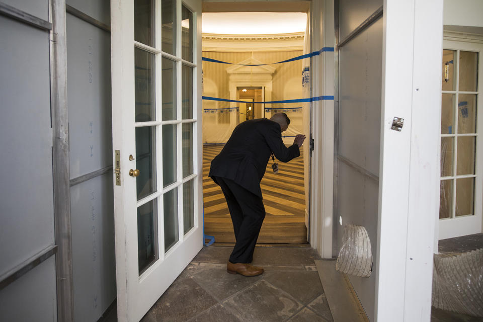 <p>A Secret Service agent checks on the Oval Office of the White House in Washington, Friday, Aug. 11, 2017, as the West Wing of the White House in Washington is undergoing renovations while President Donald Trump is spending time at his golf resort in New Jersey. (AP Photo/J. Scott Applewhite) </p>