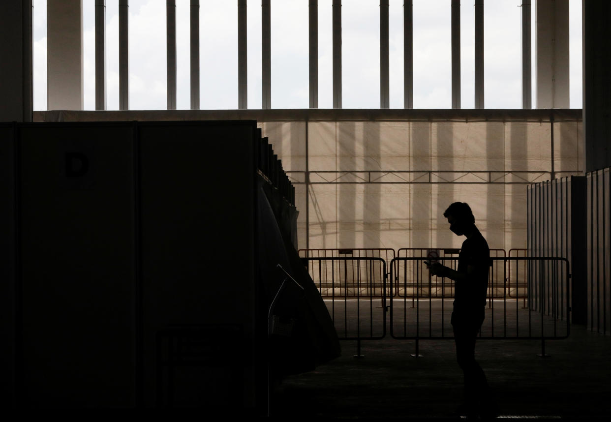 A man wearing a protective face mask is seen at a new medical facility set up for testing migrant workers residing in dormitories for the coronavirus disease (COVID-19), in Singapore May 10, 2020. REUTERS/Edgar Su