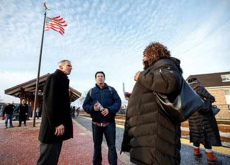 U.S. Congressman Daniel Lipinski (L) campaigns for re-election at the Chicago Ridge Metra commuter train station in Chicago Ridge, Illinois, U.S. January 25, 2018. Picture taken January 25, 2018. REUTERS/Kamil Krzacznski