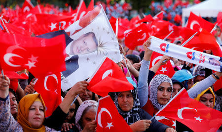 People wave national flags as they wait for Turkey's President Tayyip Erdogan arrival to the United Solidarity and Brotherhood rally in Gaziantep, Turkey, August 28, 2016. REUTERS/Umit Bektas