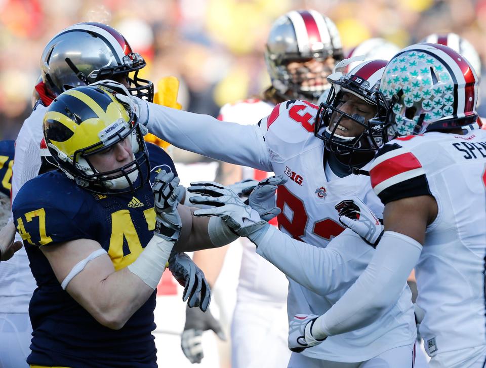 Ohio State receiver Michael Thomas (83) hits Michigan linebacker Jake Ryan in 2013.