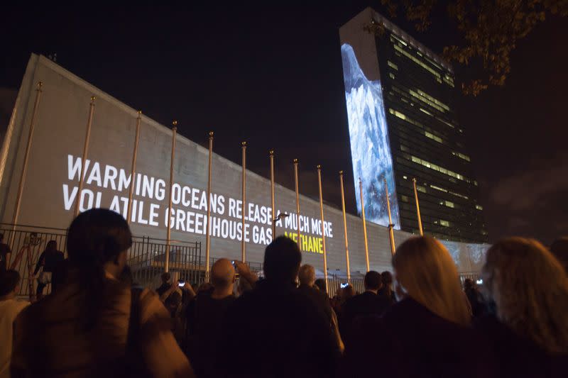 FILE PHOTO: Messages on methane gas and carbon dioxide emissions are projected onto the U.N. building ahead of climate change talks in New York