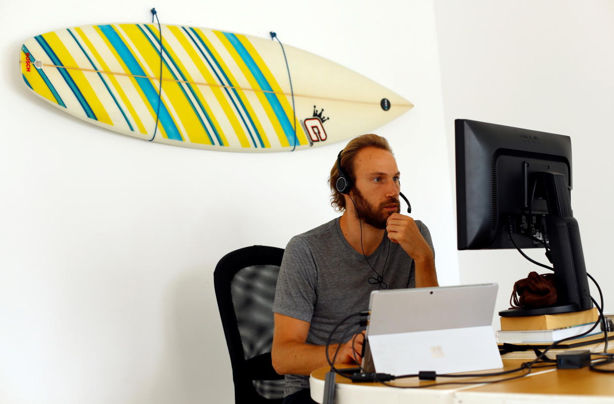 Alex Swaton, 30, from United States works remotely from Las Palmas De Gran Canaria in Gran Canaria, Spain, on July 23, 2021. REUTERS/Borja Suarez