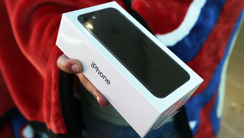 Gill Armenta leaves the Apple Store after buying an iPhone 7 at City Creek Center in Salt Lake City on Friday, Sept. 16, 2016.