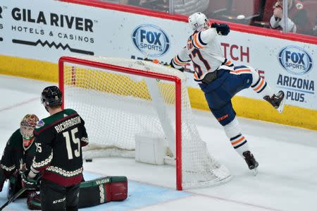 Mar 16, 2019; Glendale, AZ, USA; Edmonton Oilers center Connor McDavid (97) celebrates after scoring the game winning goal in overtime as Arizona Coyotes goaltender Darcy Kuemper (35) and center Brad Richardson (15) react at Gila River Arena. Mandatory Credit: Matt Kartozian-USA TODAY Sports