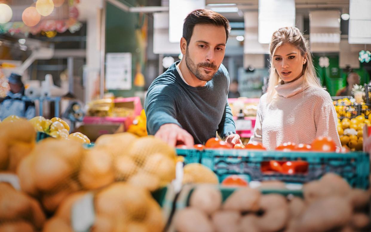 couple buying food at local supermarket