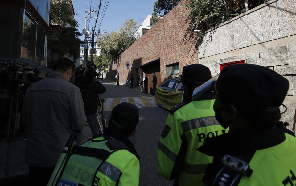 South Korean police officers stand outside of a residence of former President Lee Myung-bak in Seoul, South Korea, Thursday, Oct. 29, 2020. South Korea's top court upheld a 17-year sentence imposed on former President Lee Myung-bak for a range of corruption crimes in a final ruling Thursday that will send him back to prison. (AP Photo/Lee Jin-man)