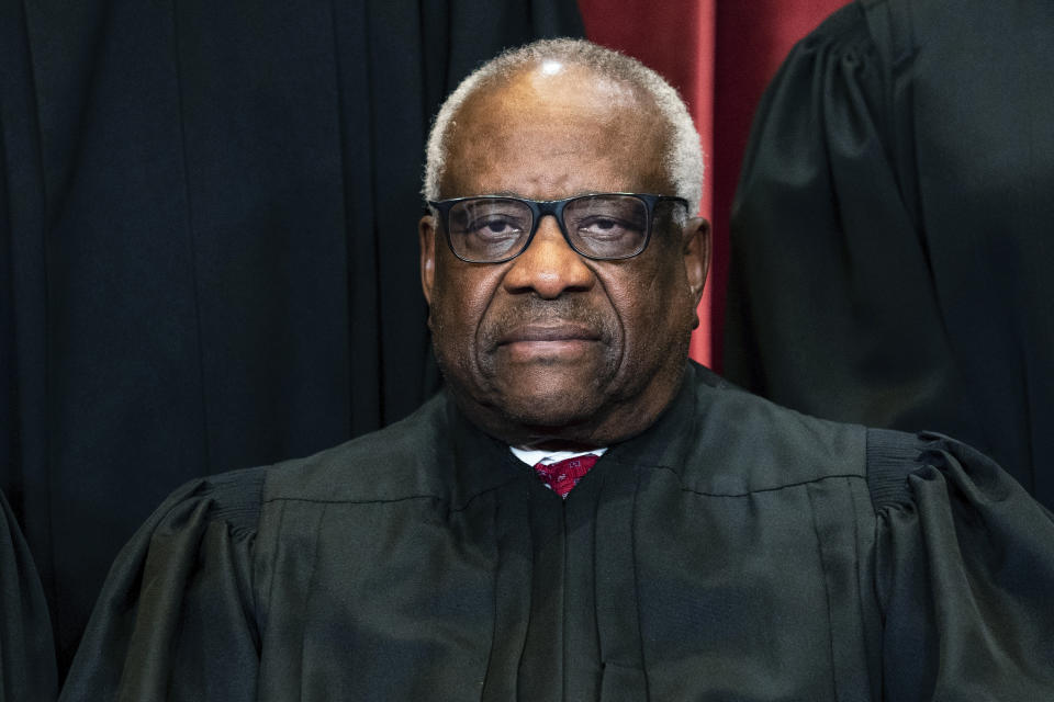 FILE - Justice Clarence Thomas sits during a group photo at the Supreme Court in Washington, on Friday, April 23, 2021. Supreme Court justices have long prized confidentiality. It's one of the reasons the leak of a draft opinion in a major abortion case last week was so shocking. But it's not just the justices' work on opinions that they understandably like to keep under wraps. The justices are also ultimately the gatekeepers to information about their travel, speaking engagements and health issues. (Erin Schaff/The New York Times via AP, Pool, File)