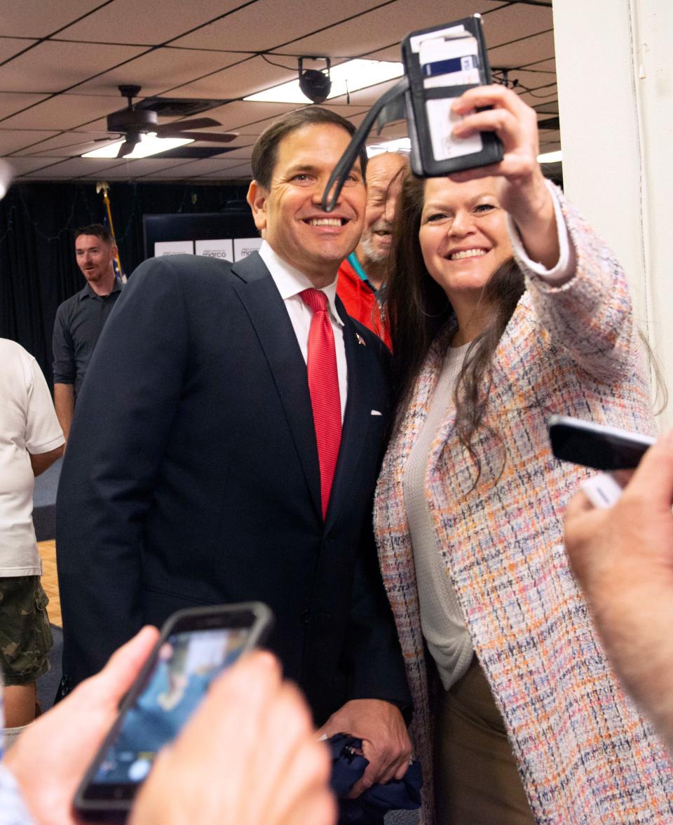 U.S. Sen. Marco Rubio snaps a photo as he meets with constituents during a visit to the American Legion Escambia Post 340 in Pensacola on Tuesday, April 12, 2022.