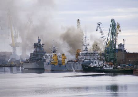 A general view shows smoke rising above a dock at the Zvyozdochka shipyard in the north Russian city of Severodvinsk, April 7, 2015. REUTERS/Oleg Kuleshov