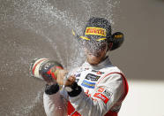 McLaren Formula One driver Lewis Hamilton of Britain sprays champagne during the podium ceremony after winning the U.S. F1 Grand Prix at the Circuit of the Americas in Austin, Texas November 18, 2012. REUTERS/Robert Galbraith (UNITED STATES - Tags: SPORT MOTORSPORT SPORT MOTORSPORT F1)