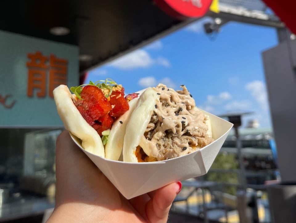 hand holding plate of bao buns at universal orlando