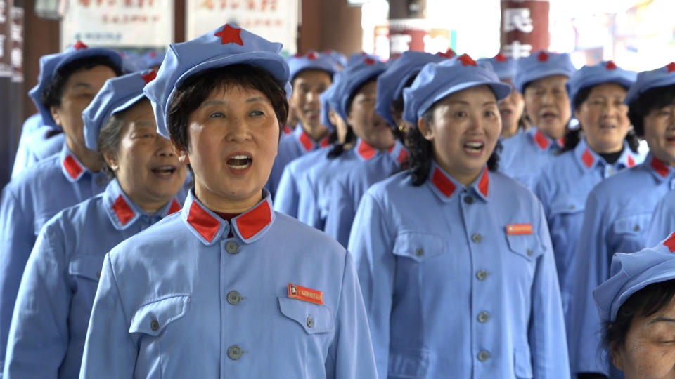 A group of local retirees gather to sing Red Army revolutionary songs in the city of Zunyi in Southwestern China's Guizhou province on April 12, 2021. The group, whose members' ages range from their late 50s to over 80, gather regularly to sing to tourists visiting the nearby Zunyi Memorial Museum. The museum, located at the site of the Zunyi Conference, was where the late Communist leader Mao Zedong rose to power. (AP Photo/Emily Wang)