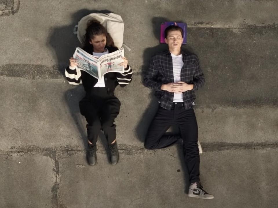 Zendaya and Tom Holland lying on a rooftop in "Spider-Man: No Way Home."