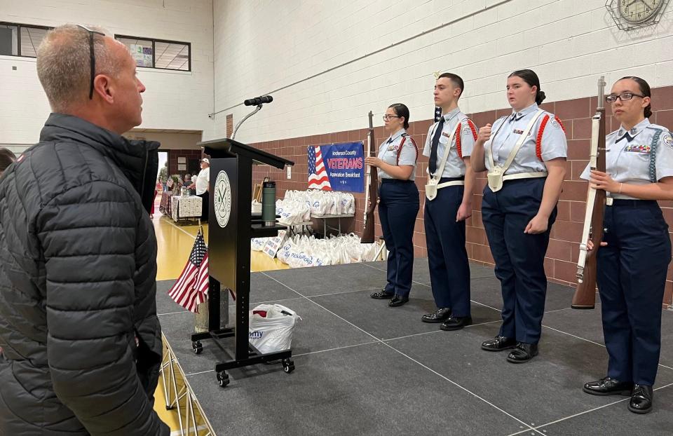 SMSgt (Ret.) Timothy Kumes (left), Clinton High School Air Force JROTC instructor, and cadets perform a practice run for the Presentation of Colors at a recent Veterans Appreciation Breakfast.