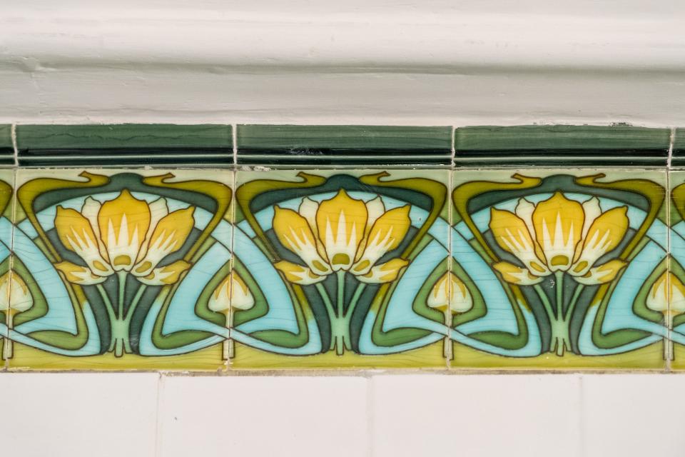 Tiles in an Art Nouveau style featuring yellow flowers