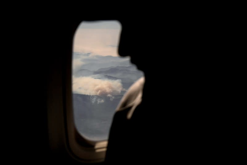 Smoke from bushfires blanket mountain ranges as seen during a commercial flight over northern New South Wales