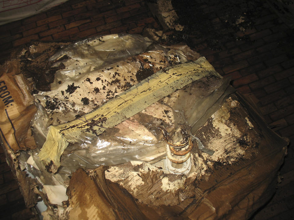 In this photo taken Aug. 6, 2012 and released Sunday, Sept. 23, 2012 by the Philippine National Museum, a water-damaged cardboard boxe containing clothes of the Marcos couple is seen at a section of the National Museum in Manila, Philippines. Termites, storms and government neglect have damaged some of Imelda Marcos's legendary stash of shoes, expensive gowns and other vanity possessions, which were left to oblivion after she and her dictator husband were driven to U.S. exile by a 1986 popular revolt. (AP Photo/Philippine National Museum) NO SALES