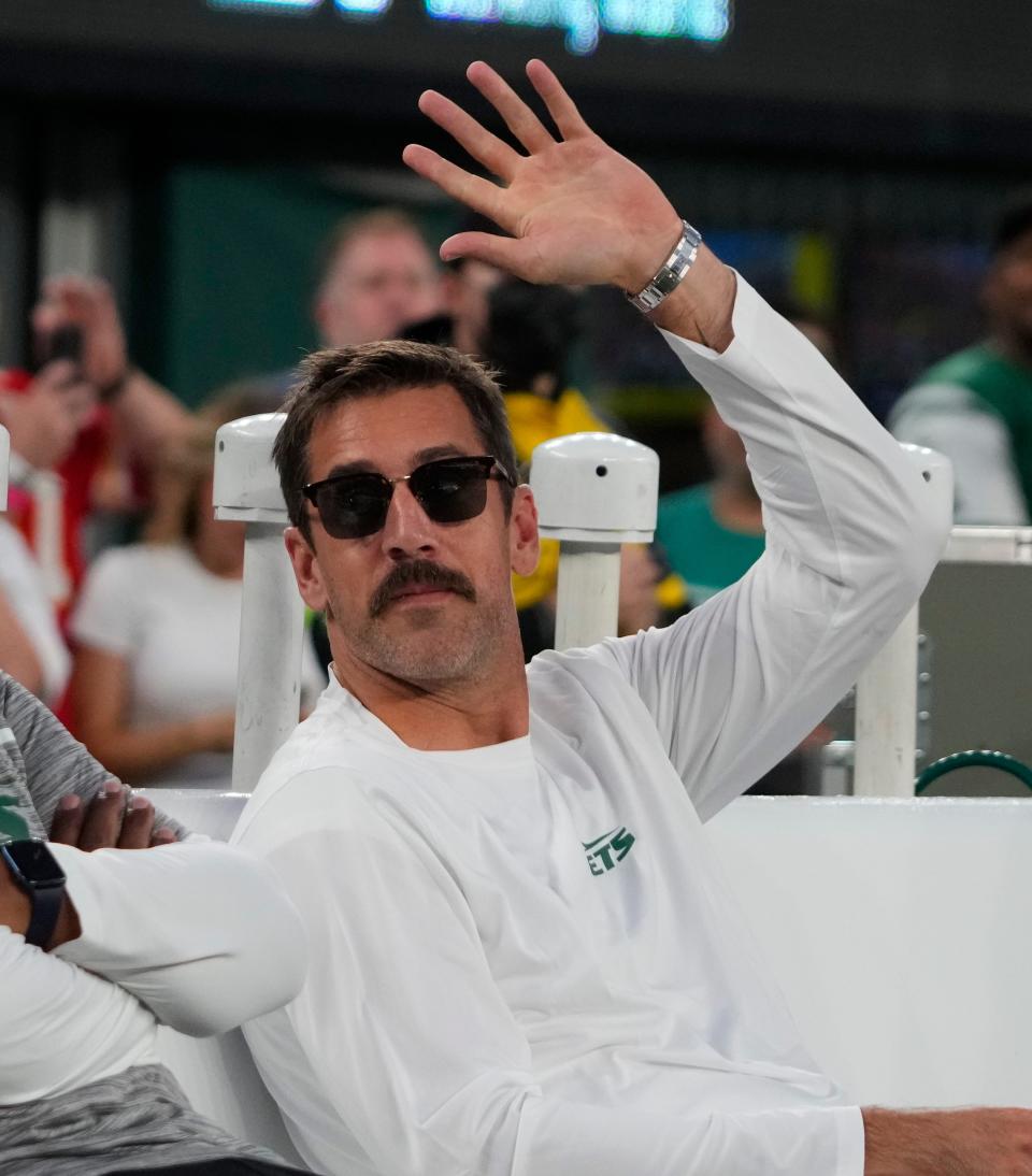 Injured New York Jets quarterback Aaron Rodgers waves to the crowd ahead of the Oct. 1, 2023, game at MetLife Stadium in New Jersey.