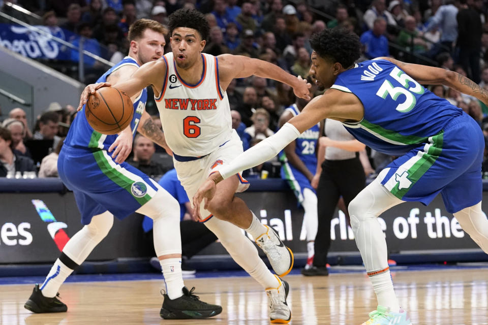 New York Knicks guard Quentin Grimes (6) drives past Dallas Mavericks defenders Luka Doncic and Christian Wood (35) during the third quarter of an NBA basketball game in Dallas, Tuesday, Dec. 27, 2022. (AP Photo/LM Otero)